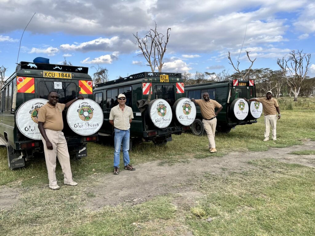 Shantanu Chand and the Oloi Shorua safari team with vehicles ready for a luxury African safari