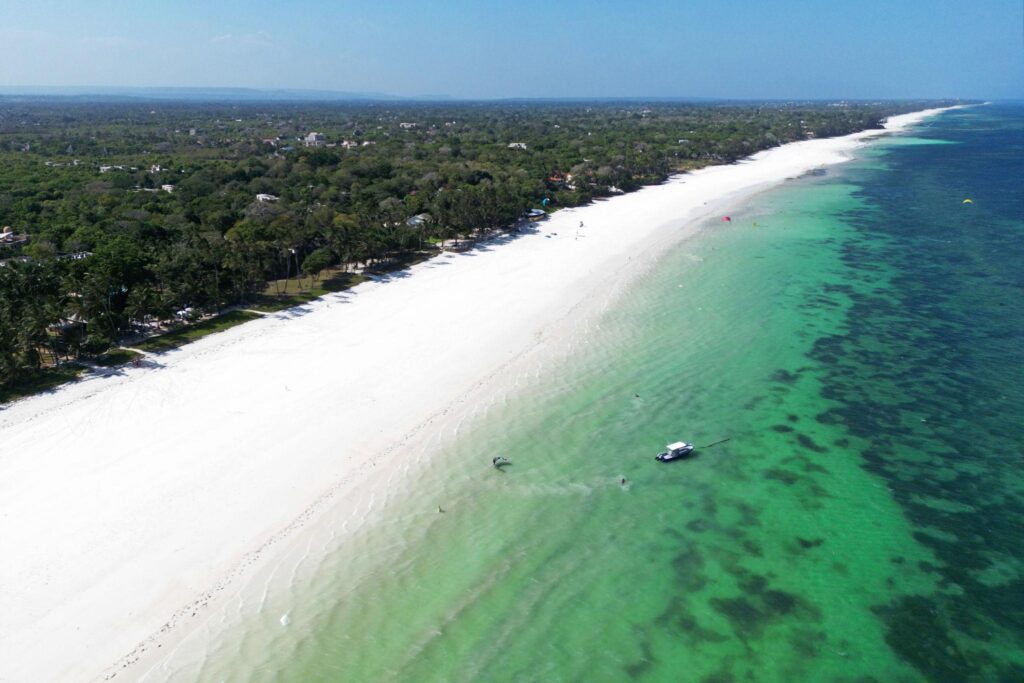 White sand beach and turquoise water along Diani Beach on the Kenya coast